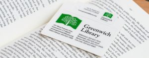 Greenwich Library card laying on an open book